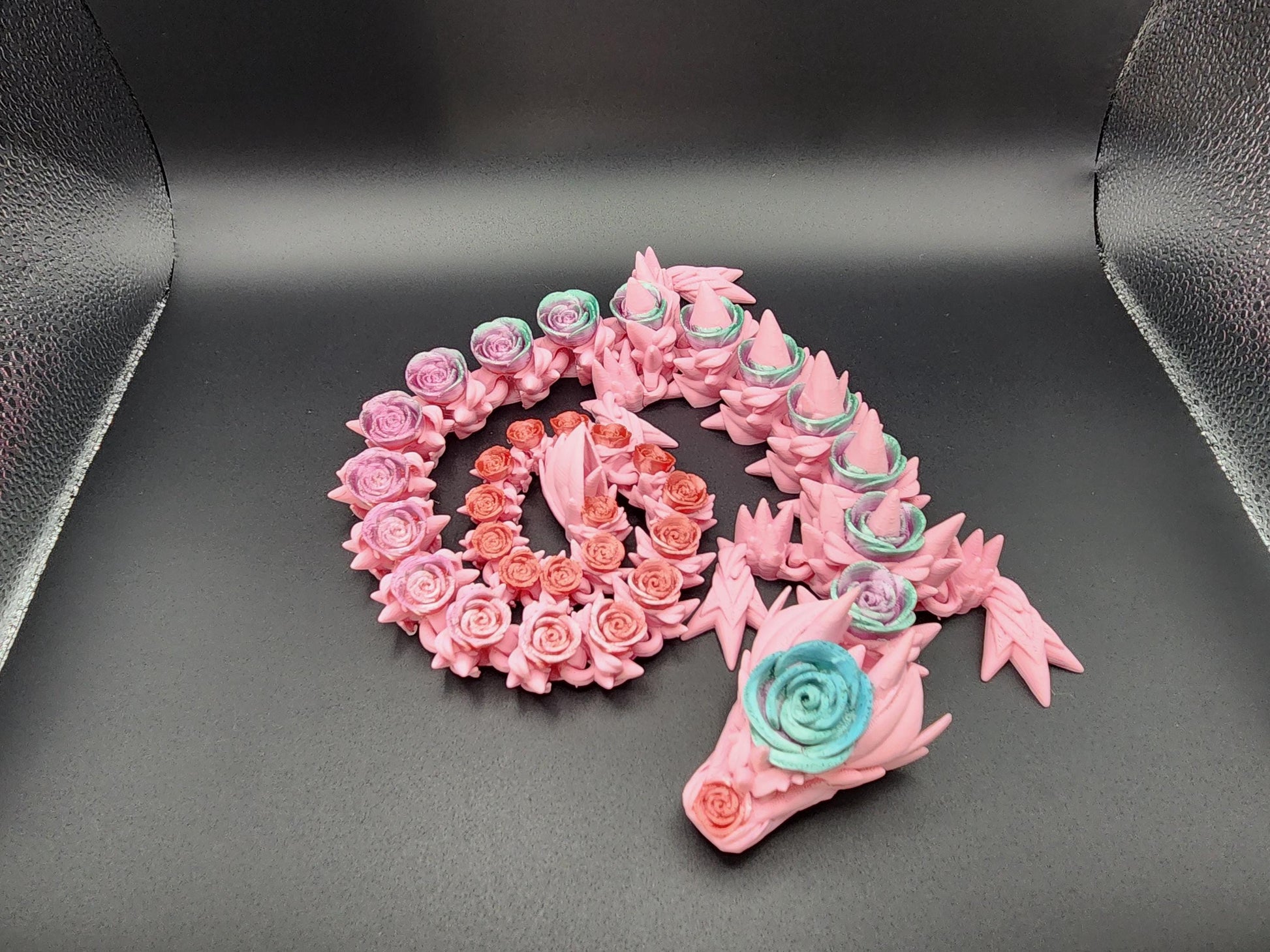 Pink 3D printed rose dragon figurine with intricate floral details and blue rose accents