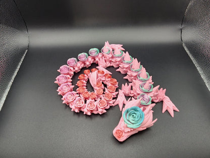 Pink 3D printed rose dragon figurine with intricate floral details and blue rose accents