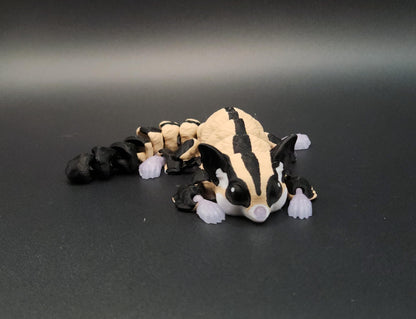 3D printed sugar glider figurine in beige and black colors on a dark background