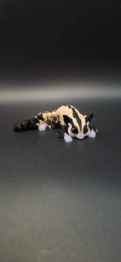 3D printed sugar glider figurine with black and beige color detail on a dark background