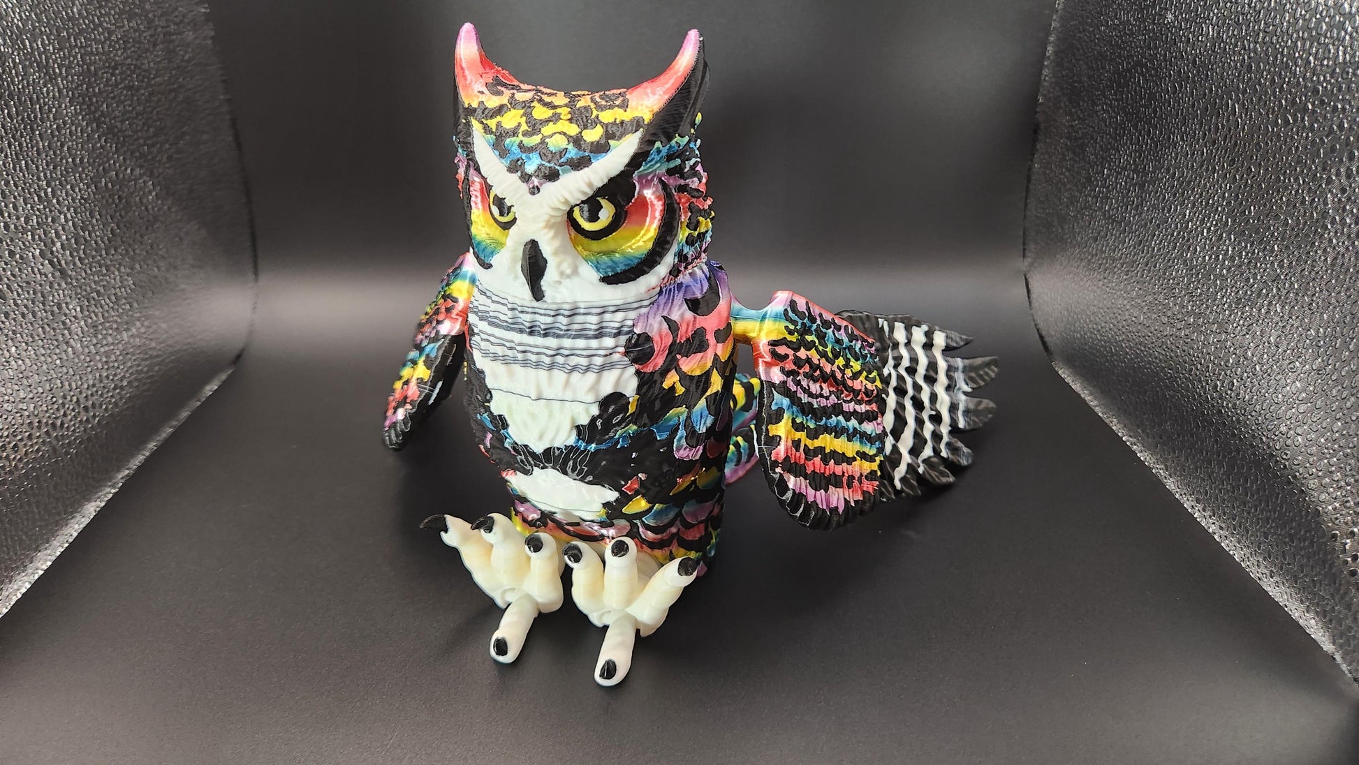 Colorful poseable articulated rainbow great horned owl figurine with detailed feathers