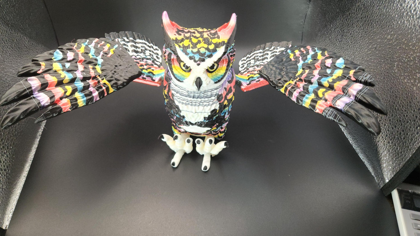 Poseable articulated rainbow great horned owl figurine with detailed colorful feathers and extended wings