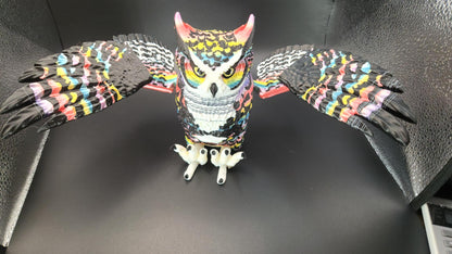 Poseable articulated rainbow great horned owl figurine with detailed colorful feathers and extended wings