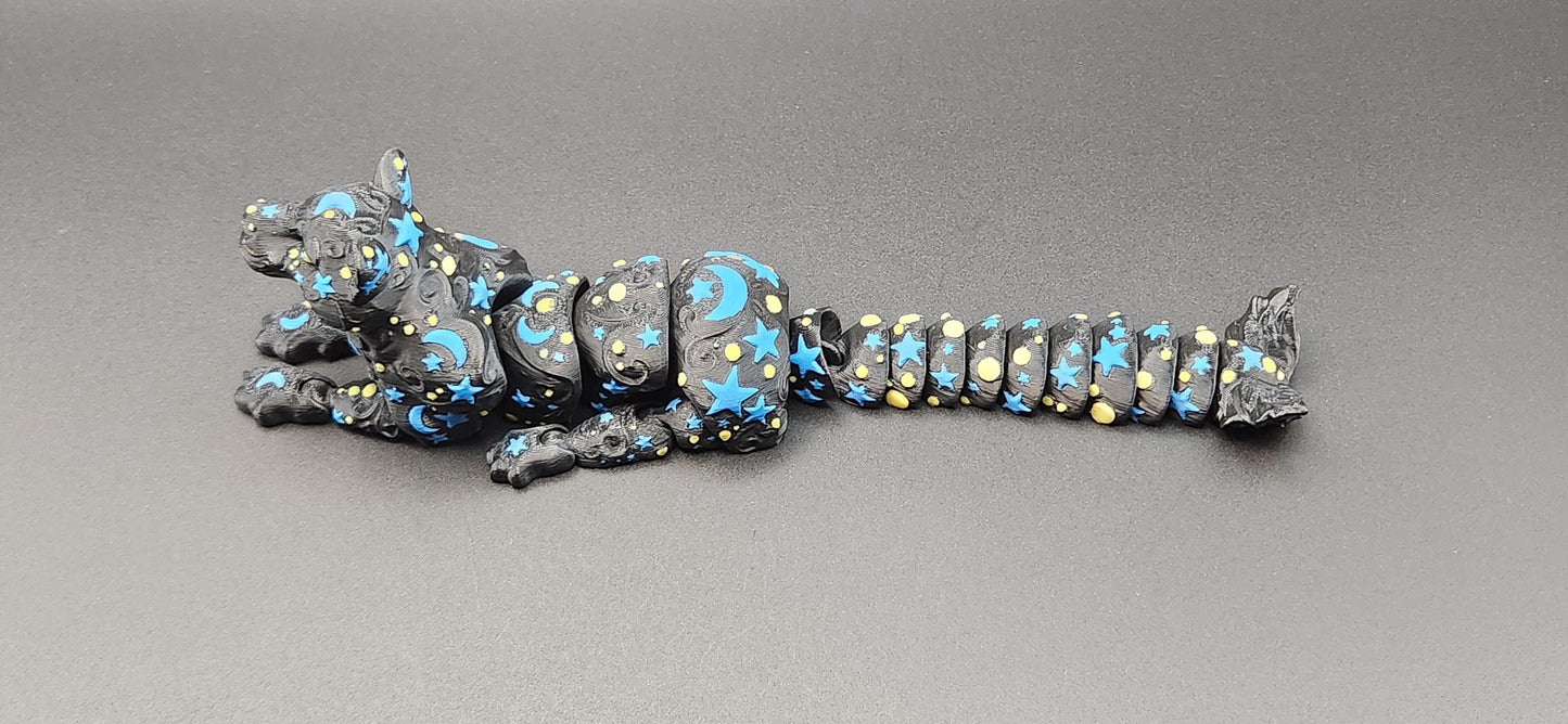 Black star and moon fidget panther toy with blue and yellow celestial patterns