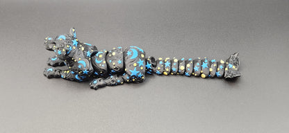Black star and moon fidget panther toy with blue and yellow celestial patterns