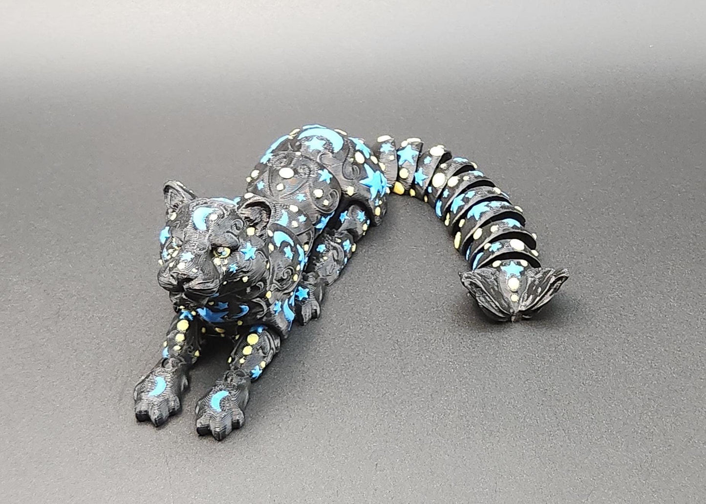 Black panther figurine with blue star and moon patterns in flexible segmented design star and moon fidget panther