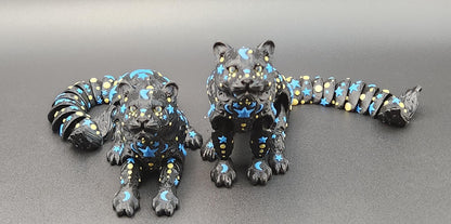 Black star and moon fidget panther figurines with blue and yellow celestial designs