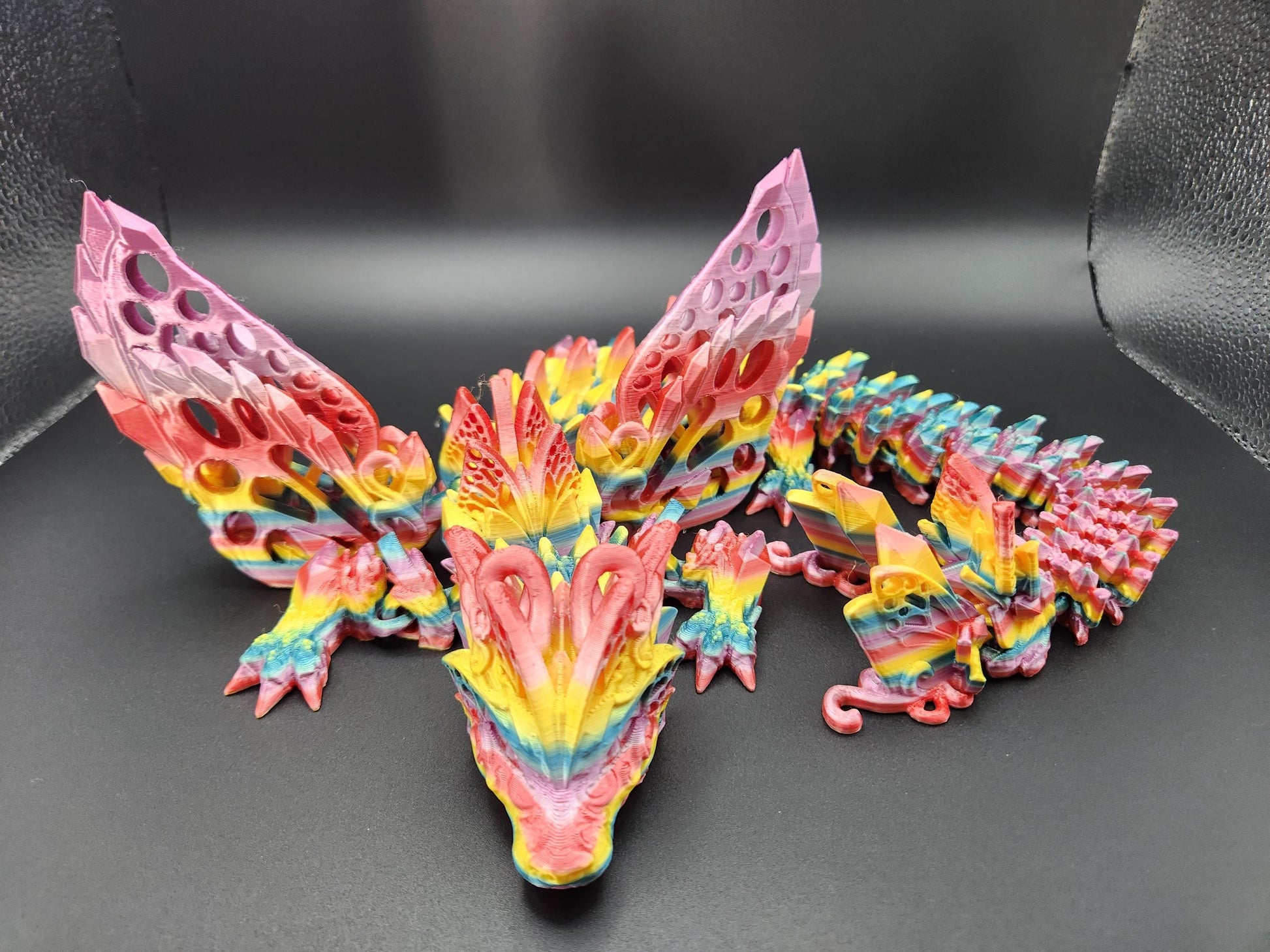 Colorful 3D printed winged crystal dragon figurine with detailed scales and large textured wings