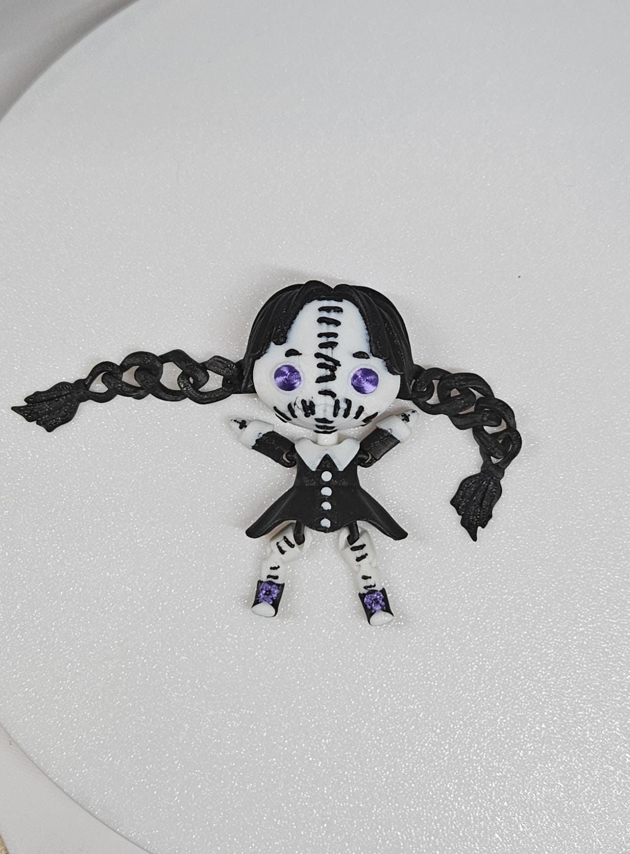 Handcrafted Wednesday articulated doll with black braided hair and purple eyes in gothic outfit
